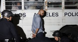 LA fights back with protesters zip-tied and loaded onto buses en masse