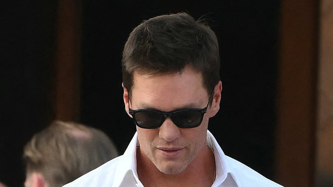 Tom Brady wears velvet slippers with plush bow at Bezos wedding party