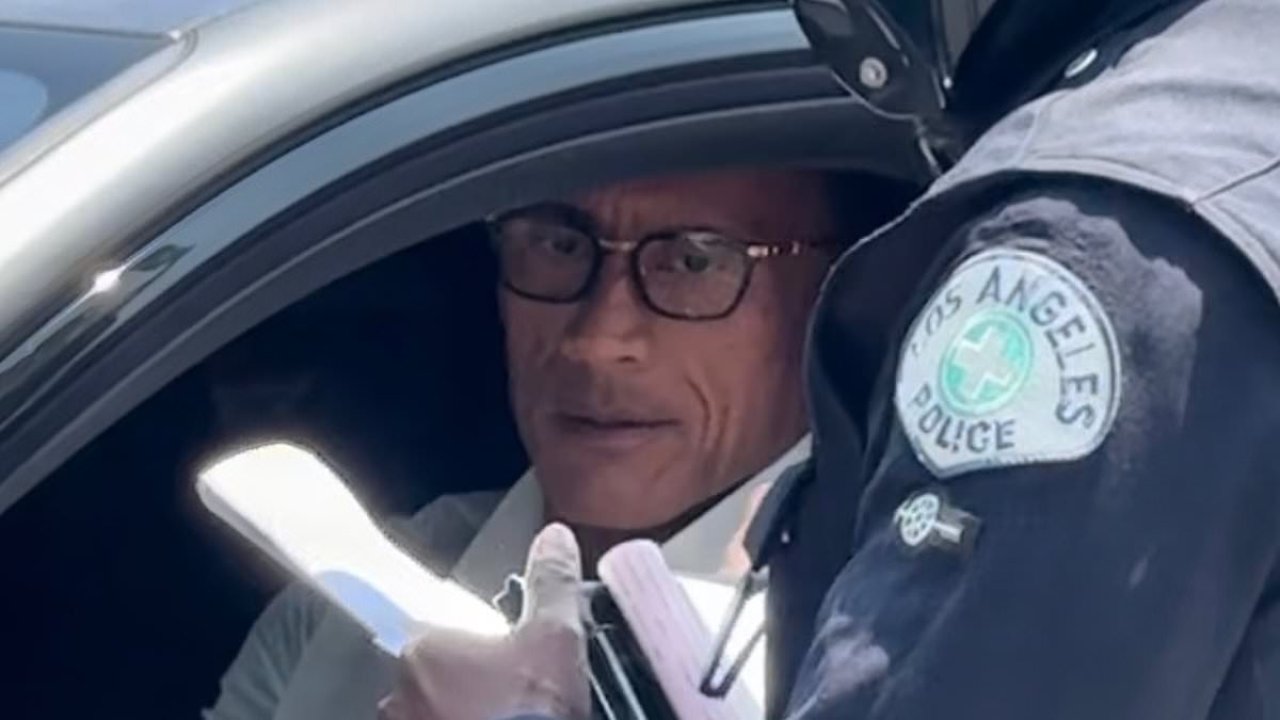Dwayne 'The Rock' Johnson looks glum as he gets PULLED OVER by police